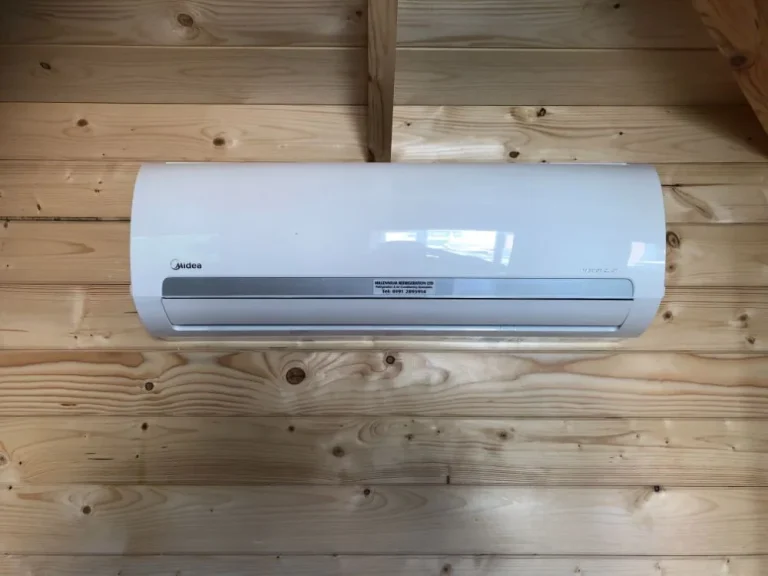 Air conditioning unit installed inside a timber-clad garden room