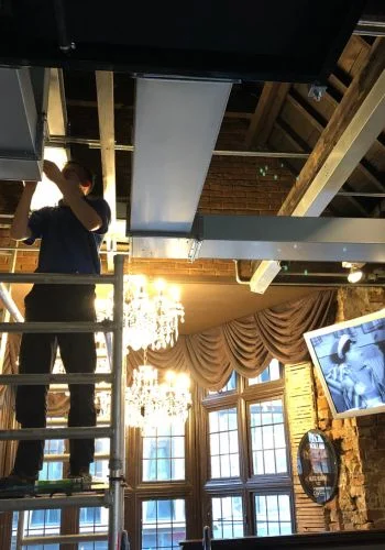 Millennium engineer installing heat recovery ductwork in a bar and restaurant